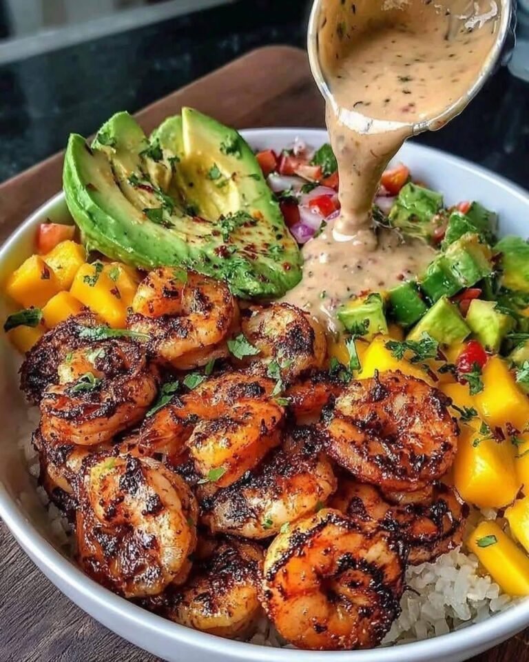 Shrimp and Avocado Bowls with juicy chili-lime shrimp, sliced avocado, fresh mango salsa, rice, colorful vegetables, and creamy lime-chili sauce.
